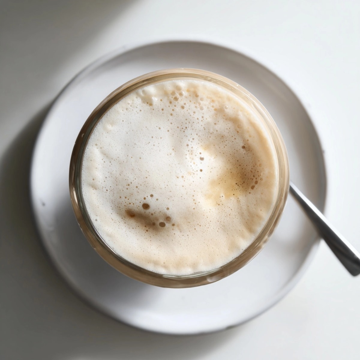 Homemade Starbucks Cold Foam: a velvety, dairy-based topping being gently spooned onto cool brew.