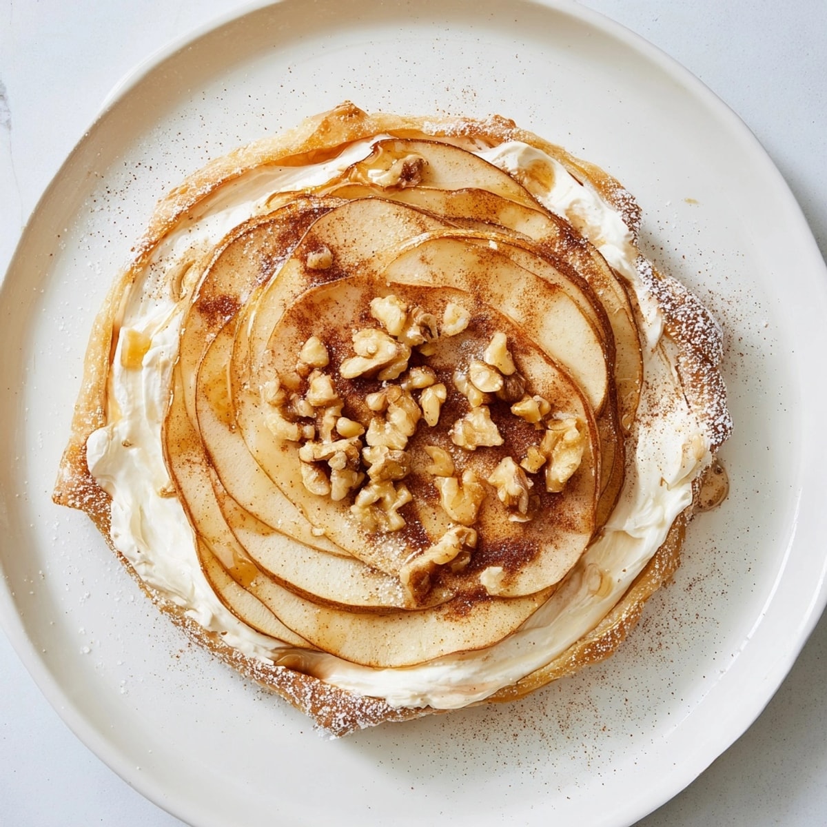 Close-up of homemade Ricotta Apple Breakfast Tarts, sprinkled with cinnamon and drizzled with honey.