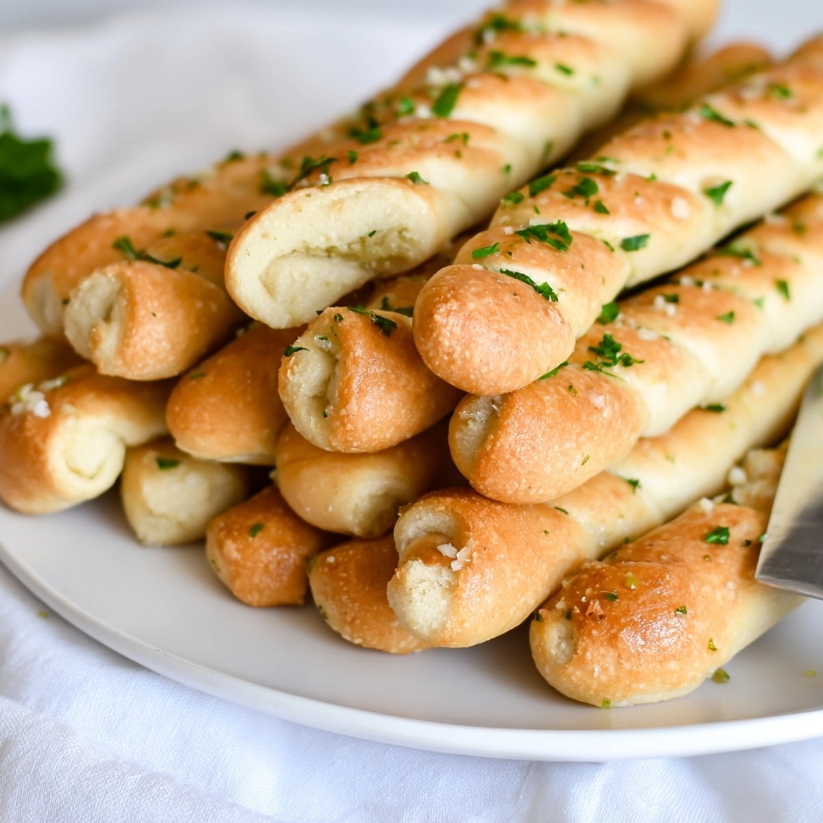 Close-up of warm, soft Garlic Onion Breadsticks, showcasing their fragrant garlic and onion topping.