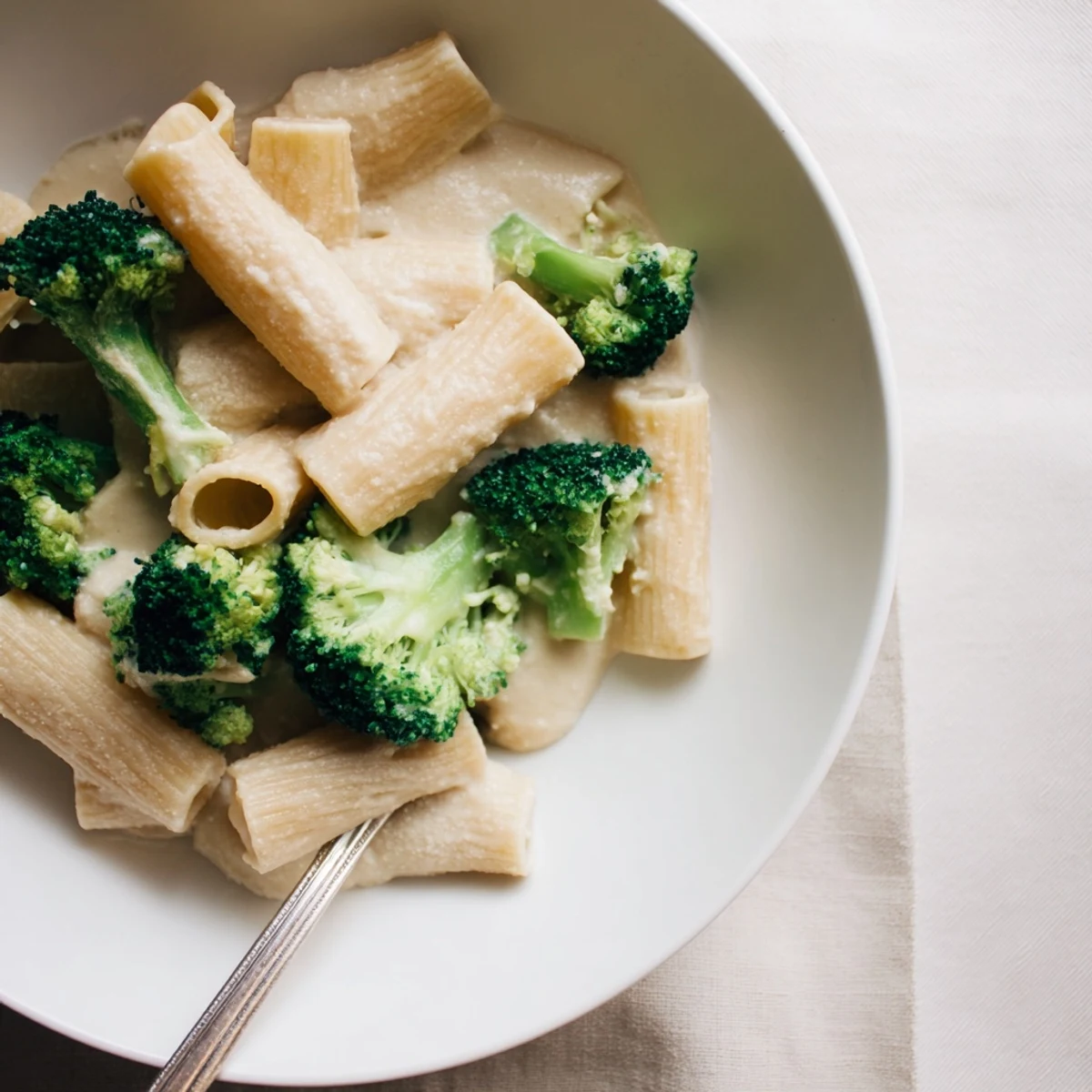 Creamy Broccoli & White Bean Alfredo served over warm pasta, perfect for dinner.  