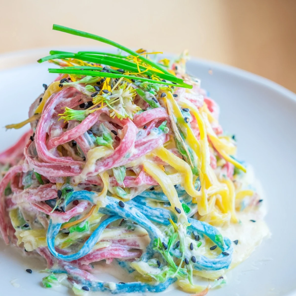 Vibrant Neon Noodle Cloud dish with colorful noodles in creamy sauce, garnished beautifully.