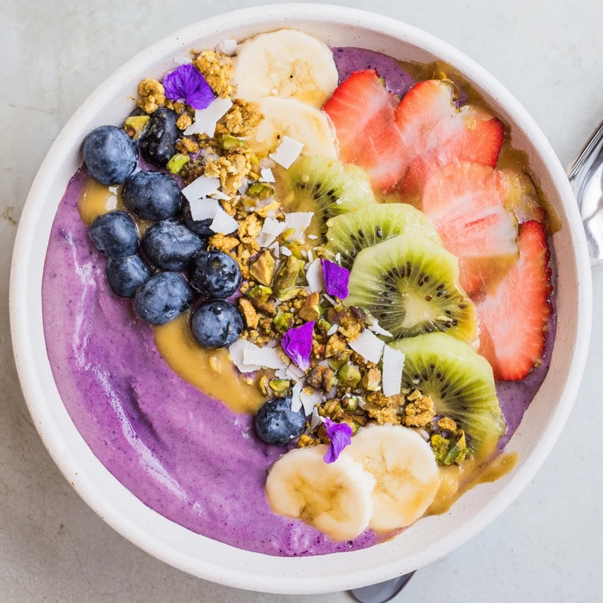 Delightful smoothie bowls filled with creamy purple yam, fruits, and coconut flakes.