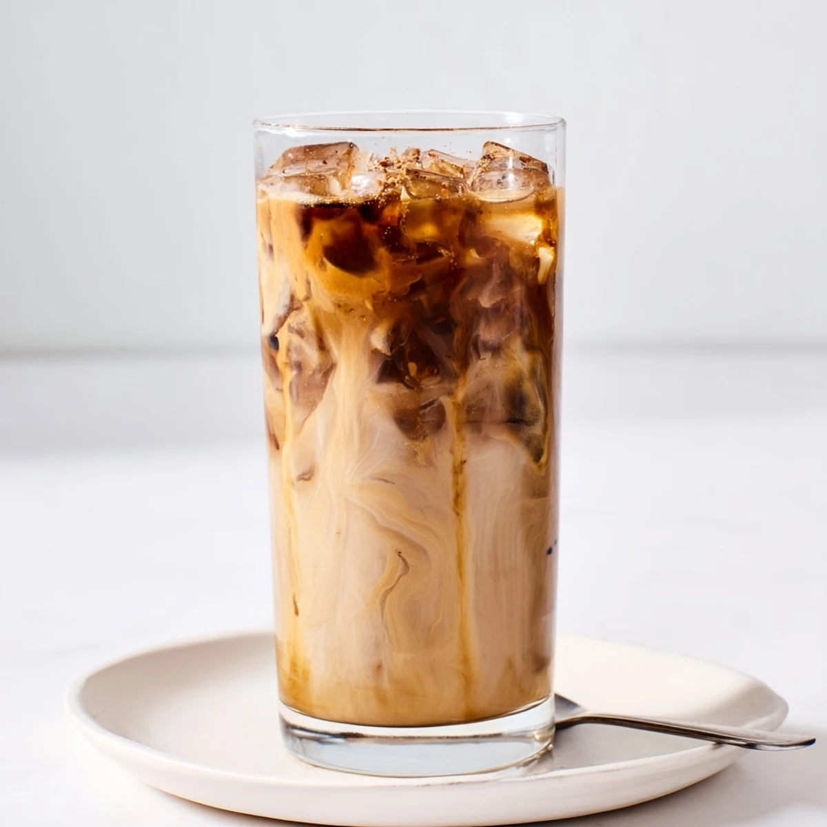 Rich and nutty Tahini Iced Coffee in a tall glass with ice.  