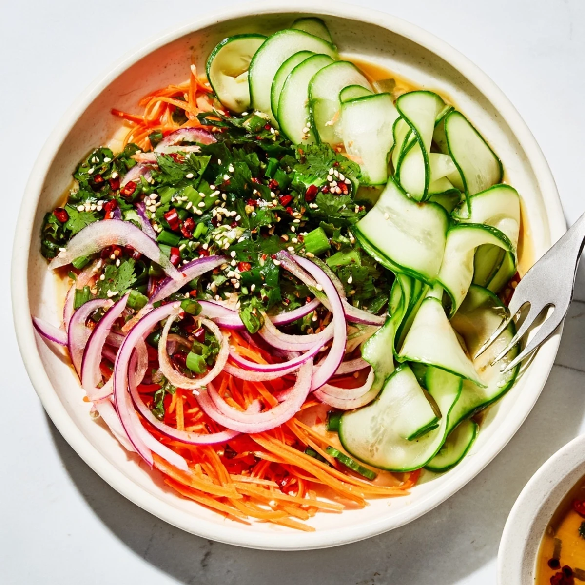 Colorful cucumber salad remix, garnished with sesame seeds for a delightful crunch.