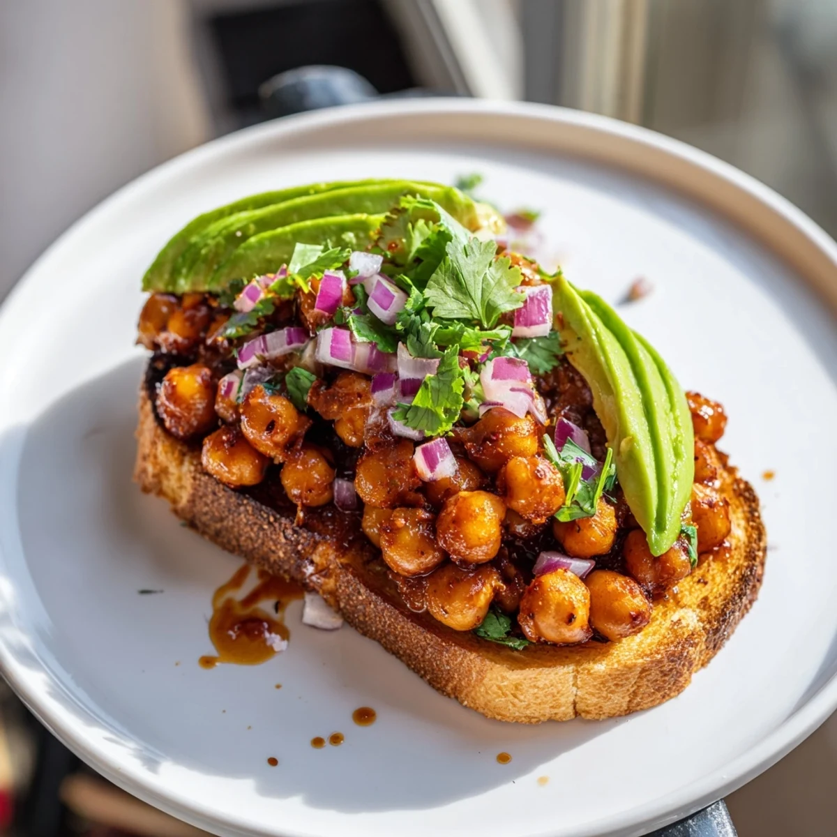 Golden, crispy toast topped with saucy, smoky BBQ chickpeas, a flavorful vegan lunch.