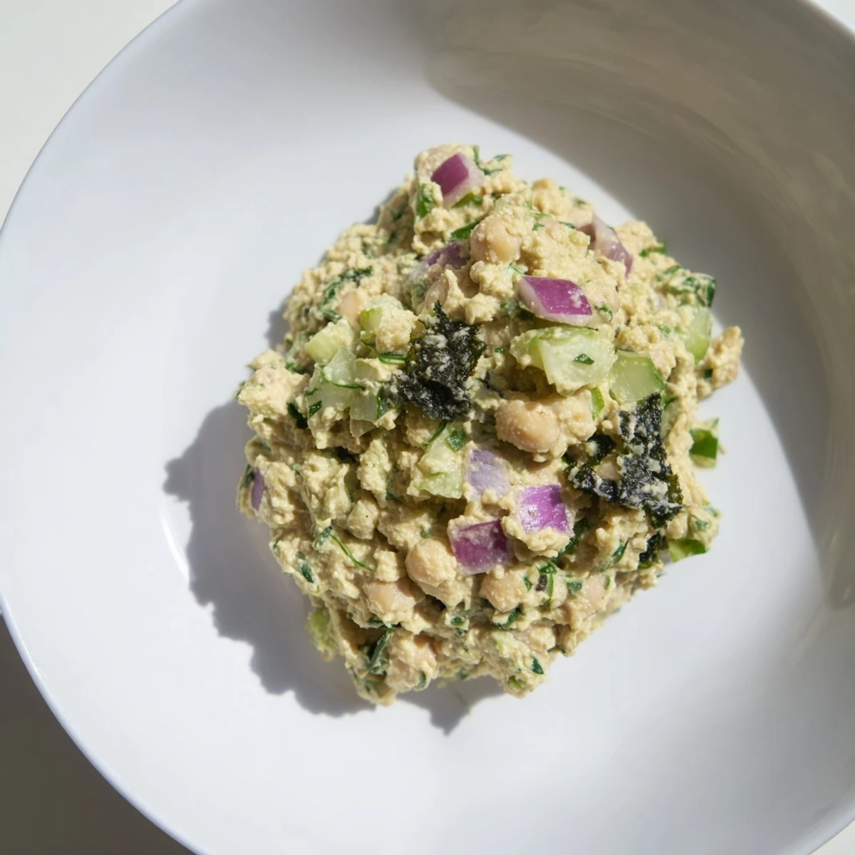 Chunky chickpea tuna salad with crispy celery and onion, perfect for a refreshing lunch wrap.