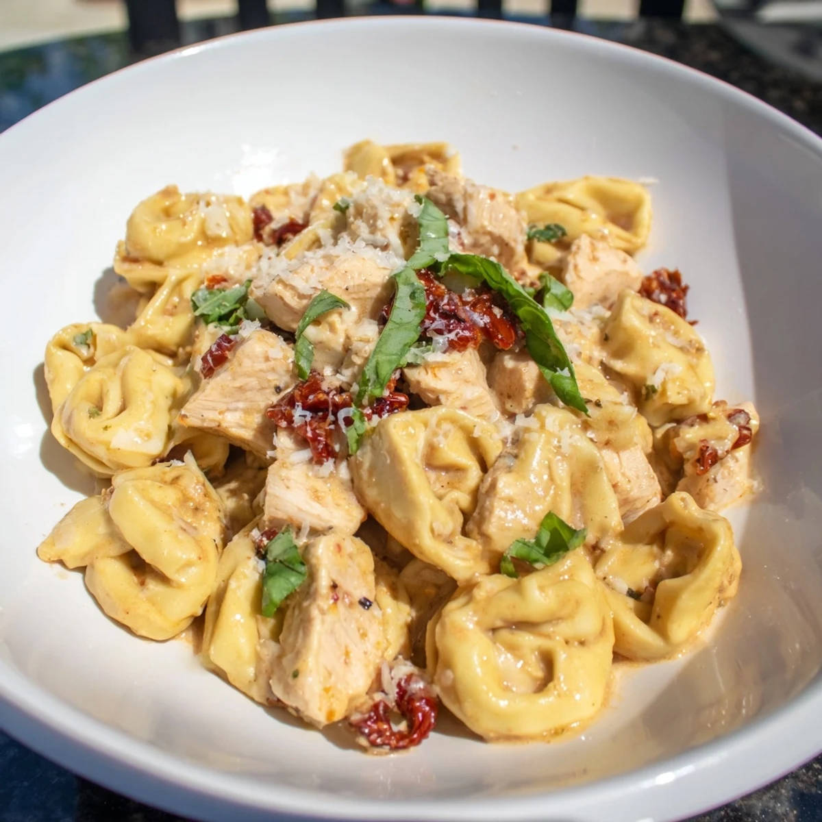 Marry Me Chicken Tortellini with sliced chicken in a rich, creamy sun-dried tomato sauce.