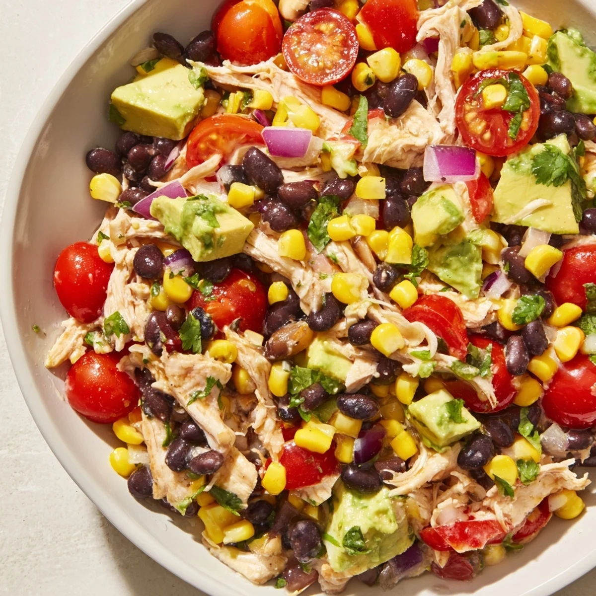 Dense Southwestern Bean Salad with vibrant colors: a refreshing, hearty salad filled with chicken.