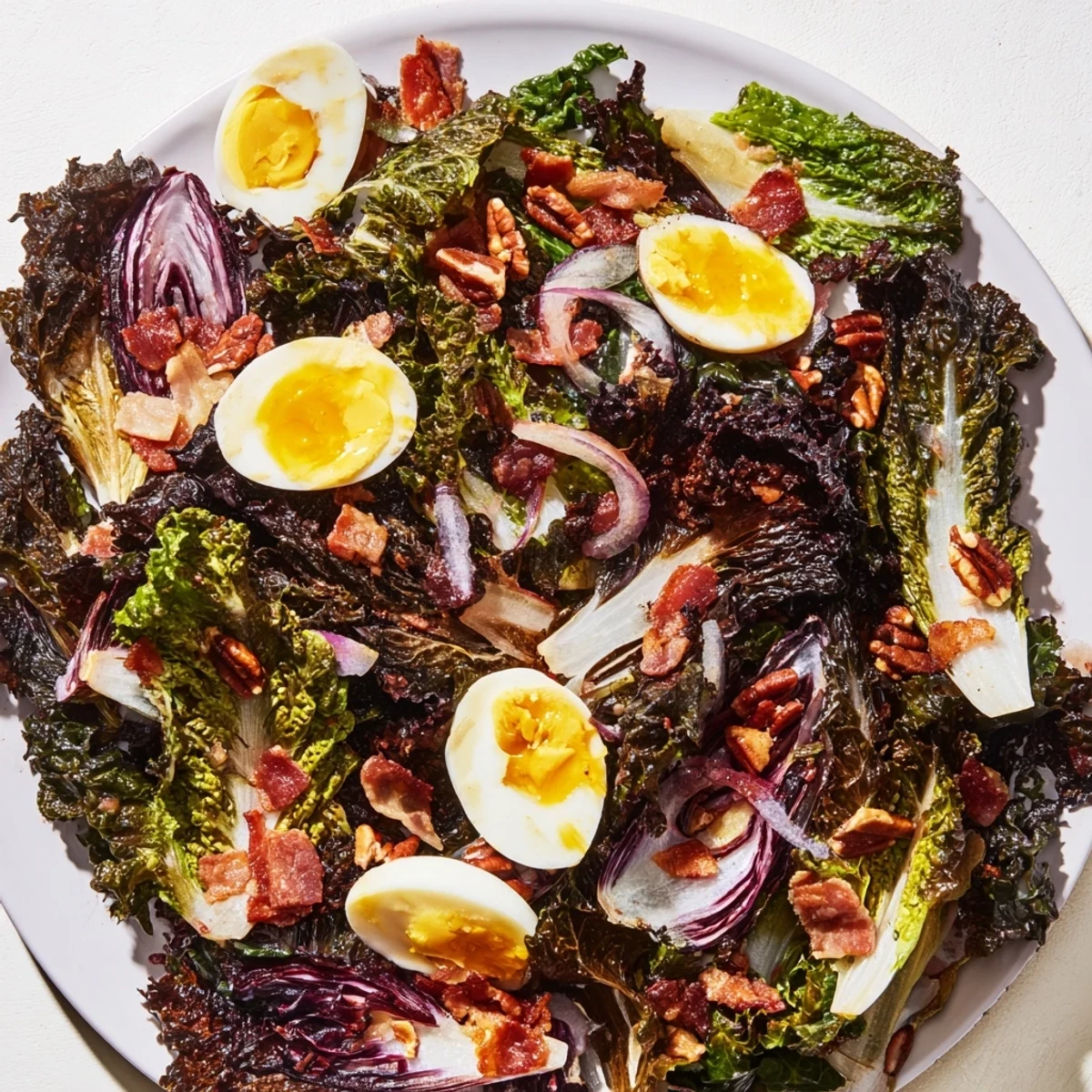 Vibrant bitter greens salad with warm bacon dressing, ready to be tossed and served.