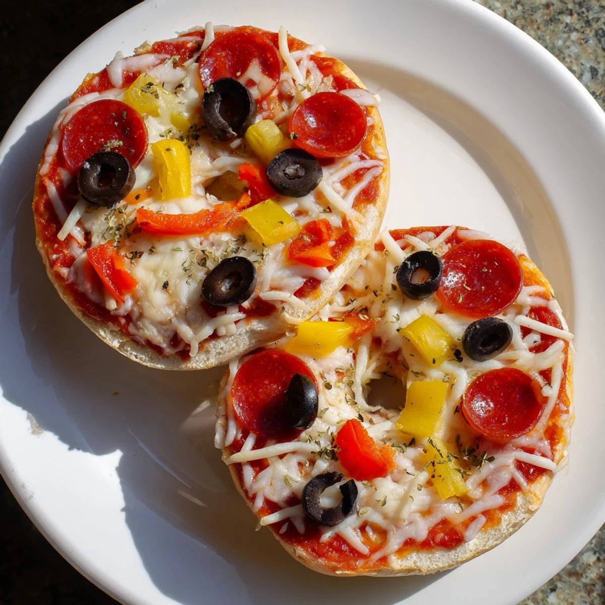 Air-fried mini bagel pizzas: a quick snack with melty cheese and flavorful Italian seasonings.