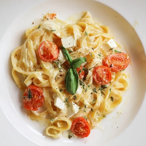 Creamy Baked Brie Pasta Sauce, bubbly with tomatoes and melted cheese, ready to be served.
