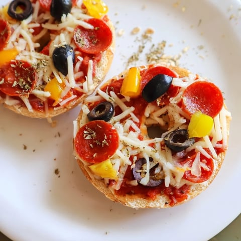 Golden, bubbly mini bagel pizzas with melted mozzarella and savory pepperoni topping.