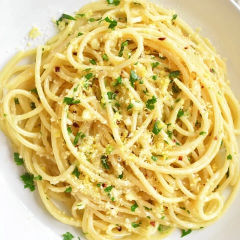 Golden, glistening garlic butter noodles, ready to be twirled and enjoyed at the dinner table.