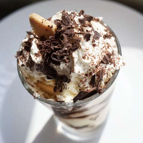 Deconstructed Tiramisu Shots in small glasses: A layer of creamy mascarpone balances intense espresso biscuits.