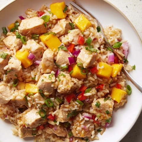 Scoops of flavorful Mango Cilantro Chicken Rice, steaming, ready to be served for dinner.