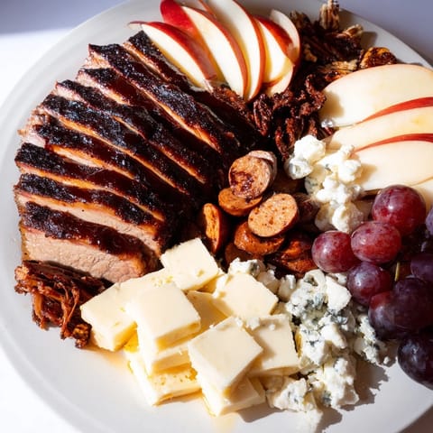 A delightful assortment: smoky meats, creamy cheeses, and dark chocolate in the Smoky BBQ & Bourbon Companion recipe.