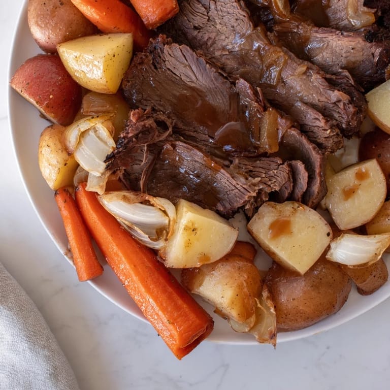 A flavorful, golden-brown Sunday Pot Roast, with accompanying carrots, potatoes, and onions glistening.