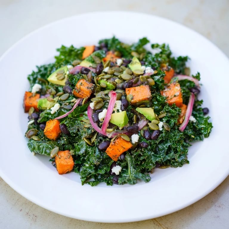 This colorful massaged kale salad combines roasted sweet potato, black beans, and avocado with a zesty dressing.