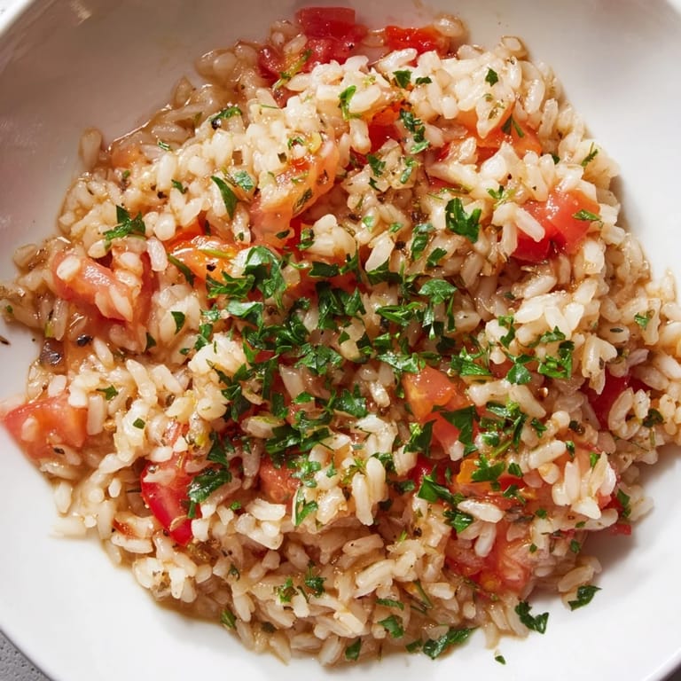 Bright red diced tomatoes and fluffy rice star in this comforting Tomato-Rice Skillet Dinner.
