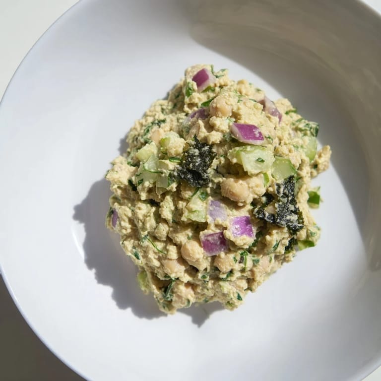 Chunky chickpea tuna salad with crispy celery and onion, perfect for a refreshing lunch wrap.