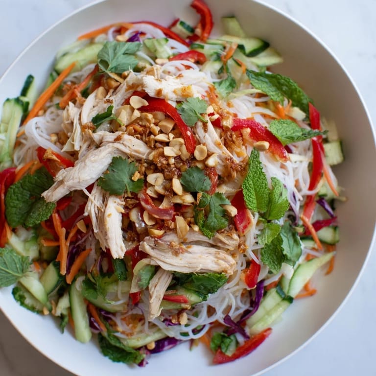 Close-up of a refreshing Vietnamese Crunch Noodle Salad with Shredded Chicken, featuring fresh herbs and veggies.